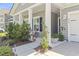 Charming exterior featuring a covered porch, lush landscaping, and welcoming curb appeal at 519 Royal Jay Ln., Longs, SC 29568