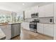 Modern kitchen showcasing stainless appliances, light countertops, hardwood flooring, and sunlit windows at 519 Royal Jay Ln., Longs, SC 29568