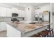 Well-equipped kitchen featuring white cabinets, stainless appliances, and a large granite countertop island at 519 Royal Jay Ln., Longs, SC 29568