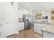 Open kitchen with stainless appliances, white cabinets, and granite counters flows seamlessly into the living space at 519 Royal Jay Ln., Longs, SC 29568