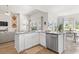 Bright kitchen featuring stainless steel appliances, white cabinetry, granite counters, and an eat-in dining area at 519 Royal Jay Ln., Longs, SC 29568
