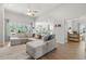 Open-concept living room featuring a large sectional and lots of natural light at 519 Royal Jay Ln., Longs, SC 29568