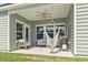 Covered patio featuring a hanging hammock chair, ceiling fan, and outdoor seating, great for relaxing at 519 Royal Jay Ln., Longs, SC 29568