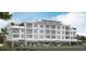 Modern multi-story building showcasing a mixed-use development with retail spaces and residential units at 5200 N Kings Hwy. # 2-E, Myrtle Beach, SC 29577