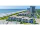 Breathtaking aerial view of an oceanfront condo complex, beach, and sparkling blue ocean on a sunny day at 5601 N Ocean Blvd. # A-307, Myrtle Beach, SC 29577