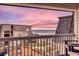 Relaxing balcony with comfortable seating offering sunset views of the pool, nearby buildings, and ocean at 5601 N Ocean Blvd. # A-307, Myrtle Beach, SC 29577