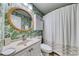 Beautiful bathroom features a vanity with a patterned shower curtain and green wallpaper at 5601 N Ocean Blvd. # A-307, Myrtle Beach, SC 29577