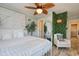 Well-decorated bedroom featuring a leafy ceiling fan and a unique accent wall at 5601 N Ocean Blvd. # A-307, Myrtle Beach, SC 29577