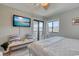 Bright bedroom with a TV, sliding glass door, bench, and comfortable furnishings at 5601 N Ocean Blvd. # A-307, Myrtle Beach, SC 29577