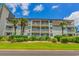 Well-maintained condo building surrounded by lush greenery and palm trees at 5601 N Ocean Blvd. # A-307, Myrtle Beach, SC 29577