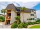 Charming condo building featuring lush landscaping, tan siding, a brown roof, and private wooden balconies at 5601 N Ocean Blvd. # A-307, Myrtle Beach, SC 29577