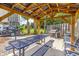 Grill area featuring a large grill, picnic table, seating, and a view of palm trees for relaxation and social gatherings at 5601 N Ocean Blvd. # A-307, Myrtle Beach, SC 29577
