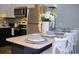 Bright kitchen featuring stainless steel appliances, stylish backsplash, navy-blue cabinets, and a marble breakfast bar at 5601 N Ocean Blvd. # A-307, Myrtle Beach, SC 29577