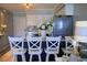 Bright kitchen featuring stainless steel appliances, stylish backsplash, navy-blue cabinets, and a marble breakfast bar at 5601 N Ocean Blvd. # A-307, Myrtle Beach, SC 29577