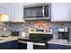A beautifully designed kitchen with modern appliances and a stylish blue tile backsplash at 5601 N Ocean Blvd. # A-307, Myrtle Beach, SC 29577