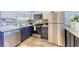 Efficient kitchen featuring stainless steel appliances, a stylish backsplash, and navy-blue cabinets at 5601 N Ocean Blvd. # A-307, Myrtle Beach, SC 29577