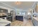 Open-concept living space with stainless steel kitchen, dining area, and cozy seating area with a balcony at 5601 N Ocean Blvd. # A-307, Myrtle Beach, SC 29577
