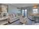 Comfortable living room with a couch, chair, and access to a balcony at 5601 N Ocean Blvd. # A-307, Myrtle Beach, SC 29577