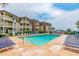 A refreshing swimming pool surrounded by comfortable lounge chairs and lush landscaping at 5601 N Ocean Blvd. # A-307, Myrtle Beach, SC 29577