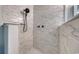 Close-up of a remodeled walk-in shower, featuring stunning tile work and black fixtures at 5601 N Ocean Blvd. # A-307, Myrtle Beach, SC 29577