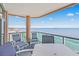 Relax on your balcony with views of the ocean, equipped with seating and a small table at 5700 N Ocean Blvd. # Ph12, North Myrtle Beach, SC 29582