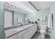 Bathroom featuring a granite countertop with double sinks, large mirror, and a toilet at 5700 N Ocean Blvd. # Ph12, North Myrtle Beach, SC 29582