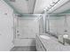 Bright bathroom featuring a granite countertop, vanity, and glass enclosed shower/tub at 5700 N Ocean Blvd. # Ph12, North Myrtle Beach, SC 29582