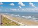 Gorgeous beach view featuring a pier and building at 5700 N Ocean Blvd. # Ph12, North Myrtle Beach, SC 29582