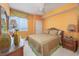 Cozy bedroom featuring a decorative bedspread, ceiling fan, and a window with a beach view at 5700 N Ocean Blvd. # Ph12, North Myrtle Beach, SC 29582