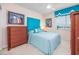 Stylish bedroom with blue accents, including a padded headboard and ocean views at 5700 N Ocean Blvd. # Ph12, North Myrtle Beach, SC 29582