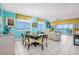 Bright dining room with modern chandelier and ocean view through the windows at 5700 N Ocean Blvd. # Ph12, North Myrtle Beach, SC 29582