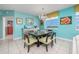Dining room with table set for six, chandelier, and ocean view at 5700 N Ocean Blvd. # Ph12, North Myrtle Beach, SC 29582