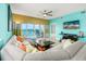Bright living room with ocean view through sliding glass doors to balcony at 5700 N Ocean Blvd. # Ph12, North Myrtle Beach, SC 29582