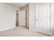 Bright bedroom with neutral carpet, a doorway and fresh paint at 575 Strawberry Field Way, Galivants Ferry, SC 29544