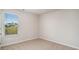 Bright bedroom with neutral carpet, fresh paint, and a window offering a view at 575 Strawberry Field Way, Galivants Ferry, SC 29544