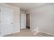 Bright bedroom features neutral carpet, fresh paint, and white trim, creating a cozy and inviting space at 575 Strawberry Field Way, Galivants Ferry, SC 29544
