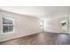 Bright living room with wood-look flooring and large windows, perfect for relaxation and entertainment at 575 Strawberry Field Way, Galivants Ferry, SC 29544