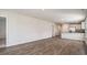 Open-concept living space featuring wood-look floors, with views of the kitchen and dining area at 575 Strawberry Field Way, Galivants Ferry, SC 29544