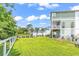 Expansive backyard with lush green grass, mature trees, and white fencing, offers ample space for outdoor activities at 601 46Th Ave. S, North Myrtle Beach, SC 29582