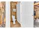 Small bathroom conveniently located in the garage includes a toilet and small sink space at 601 46Th Ave. S, North Myrtle Beach, SC 29582
