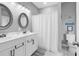 Bathroom with double sinks, white vanity, and decorative framed mirrors at 601 46Th Ave. S, North Myrtle Beach, SC 29582