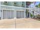 Exterior shot of the house featuring garage doors, stairs to the porch, and well-maintained landscaping at 601 46Th Ave. S, North Myrtle Beach, SC 29582