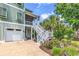 Charming home exterior featuring a well-manicured lawn, flowering plants, and an inviting staircase to the porch at 601 46Th Ave. S, North Myrtle Beach, SC 29582
