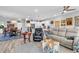Open-concept living room featuring hardwood floors, a neutral color palette, and a kitchen with modern white cabinetry at 601 46Th Ave. S, North Myrtle Beach, SC 29582