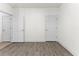 Spacious room featuring wood-look flooring, base molding, and white painted doors at 6010 Windsor Green Way # 301, Myrtle Beach, SC 29579