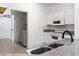 Cozy kitchen with white cabinets, granite countertops, and modern appliances including washer and dryer at 6010 Windsor Green Way # 301, Myrtle Beach, SC 29579