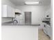 Bright kitchen featuring white cabinets, updated appliances, and a breakfast bar for casual dining at 6010 Windsor Green Way # 301, Myrtle Beach, SC 29579
