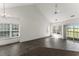 Bright, spacious living room with vaulted ceilings, ceiling fan, and sliding door access to the outside at 6010 Windsor Green Way # 301, Myrtle Beach, SC 29579