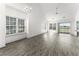 Bright living room with high ceilings, lots of natural light, and modern, gray-toned flooring at 6010 Windsor Green Way # 301, Myrtle Beach, SC 29579