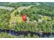 Beautiful aerial shot showcasing the home's riverfront location, surrounded by mature trees at 6161 Inman Circle, Conway, SC 29526